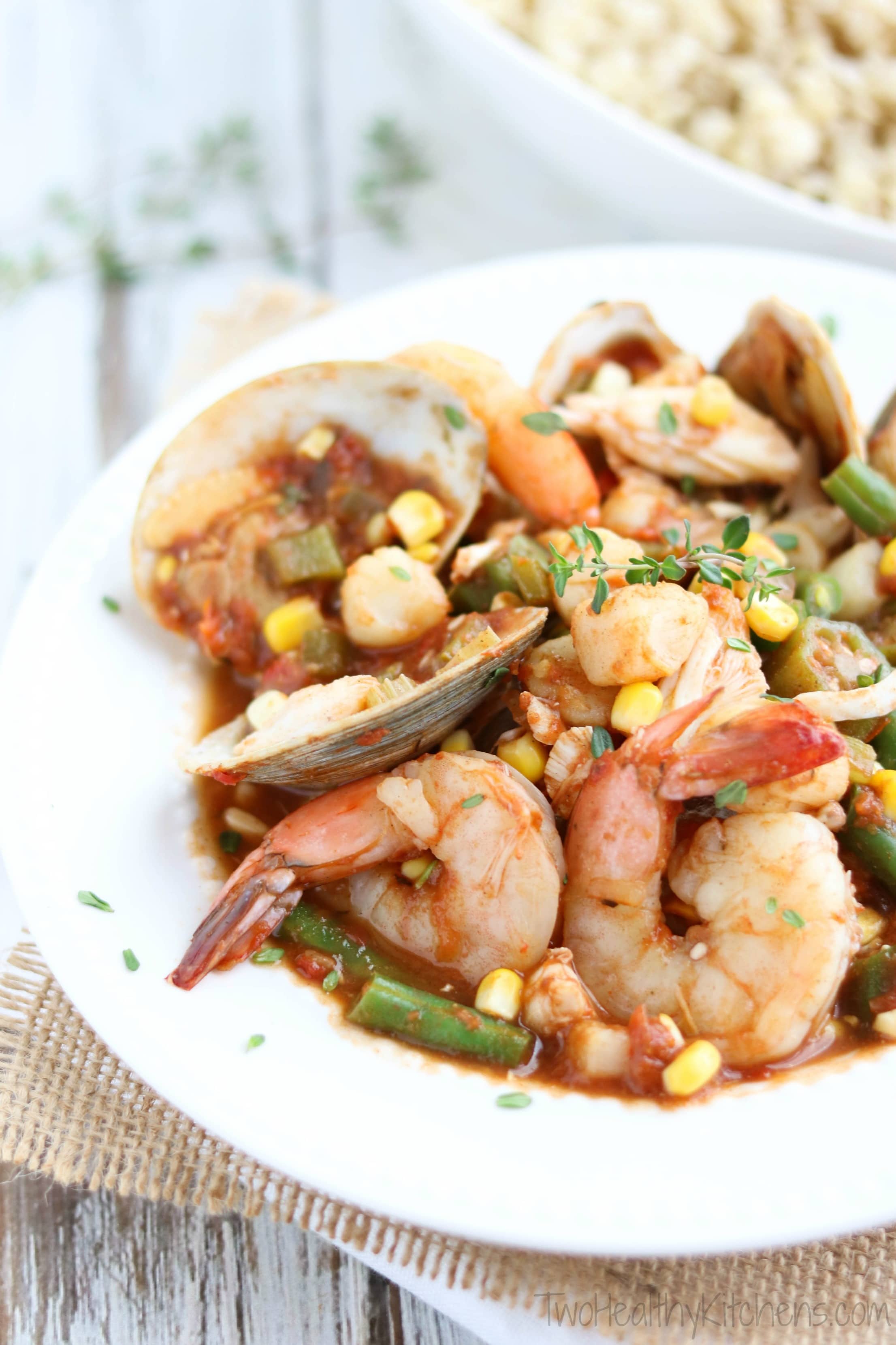 Sea Island Seafood Stew in a white bowl with burlap
